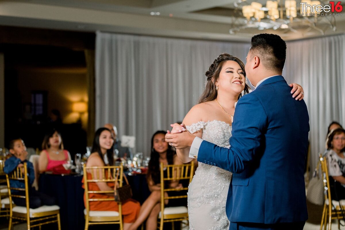 Bride and Groom gaze into each other's eyes during their first dance