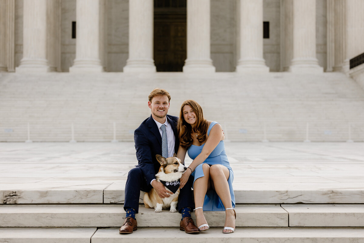 A couple in front of a landmark in DC with their dog, portrait captured by Brandgo Photography