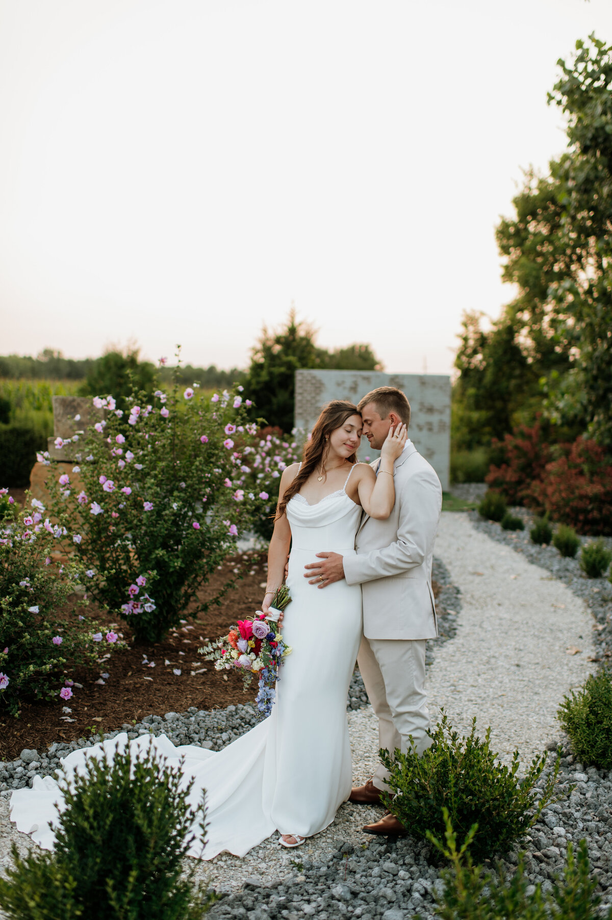 Bride walking down outdoor garden path