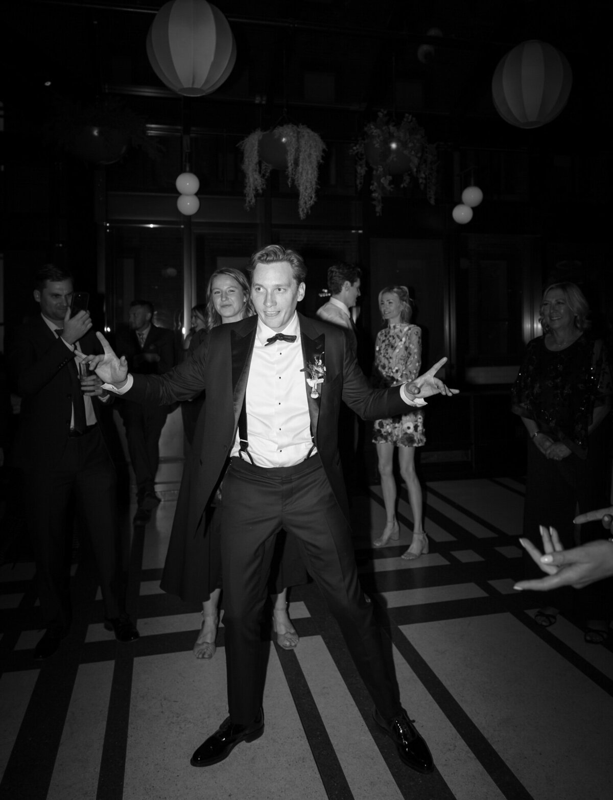 black and white candid wedding photographer, groom dances at Shinola Hotel wedding