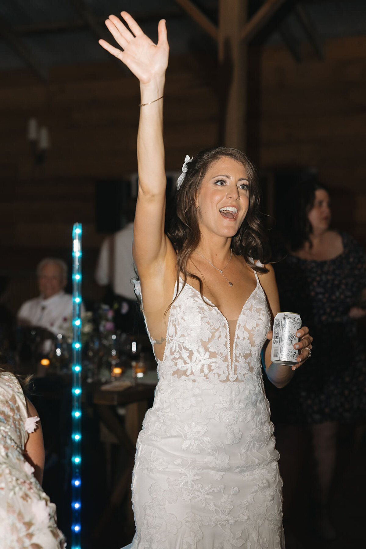 Bride dancing with her arm in the air at the reception