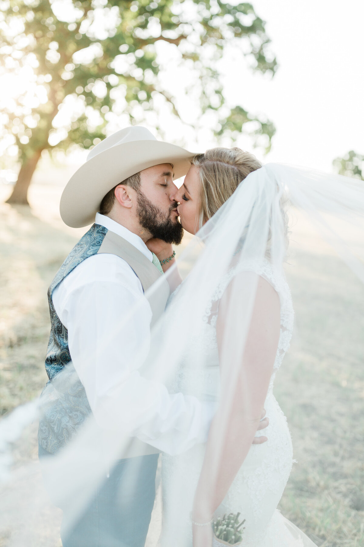 country wedding bride and groom kissing