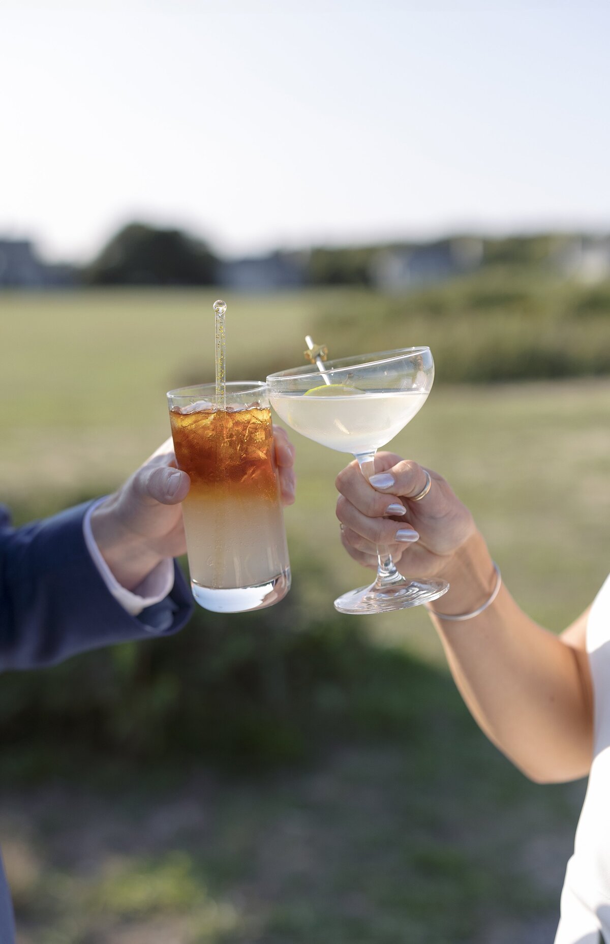 Close up detail of Bride and Groom with their cocktails during wedding reception.