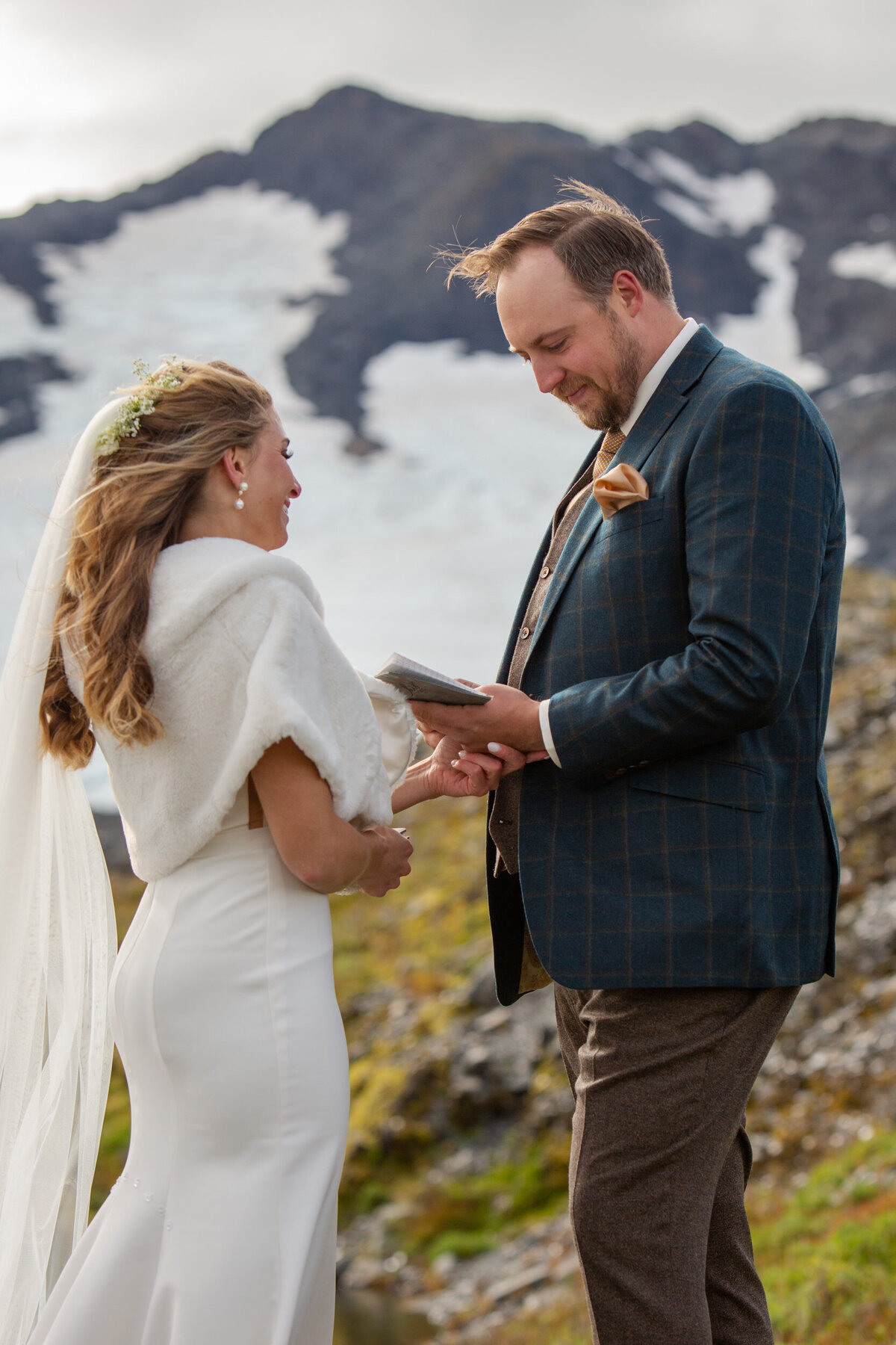 A groom reads his vows to his wife during their Elopement ceremony in Alaska.