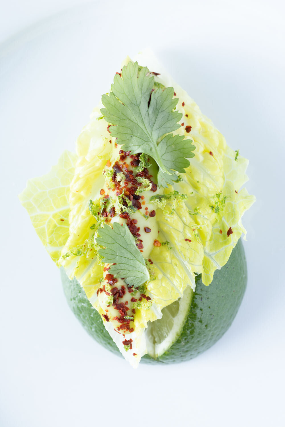 Leafy green wedge with lime, chili, and cilantro