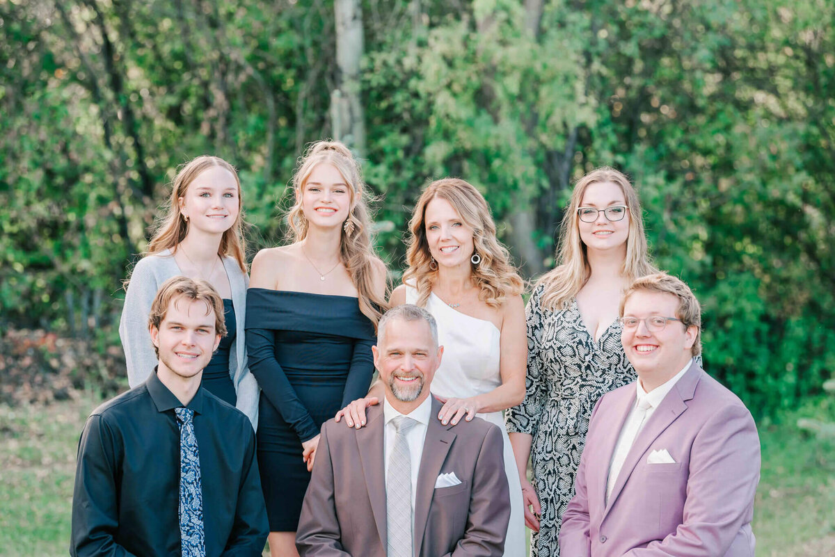 Bride and groom standing with their families.