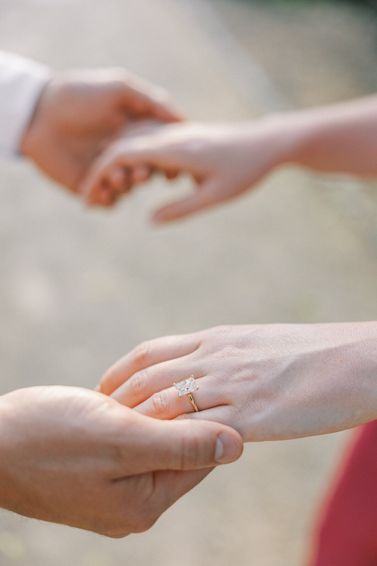 Close-up of engagement ring and couple holding hands in Columbus session by Philly-based wedding photographer.