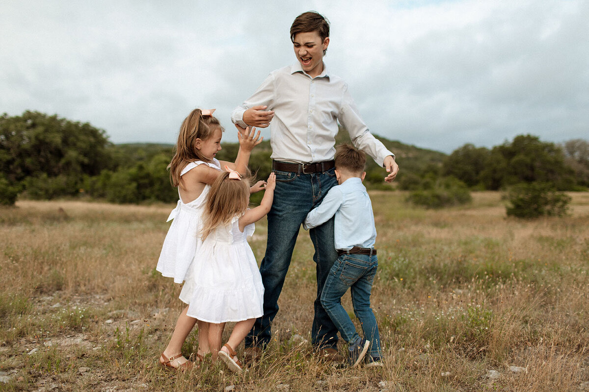 Family enjoying outdoor playtime together - Sara James specializes in capturing active family fun and recreational moments during professional photography sessions in San Antonio Texas parks and natural areas