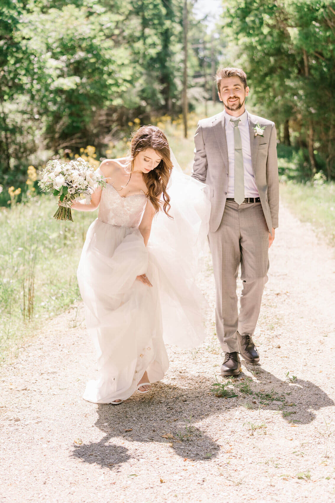 Christina and Bob wedding - bride holding up dress