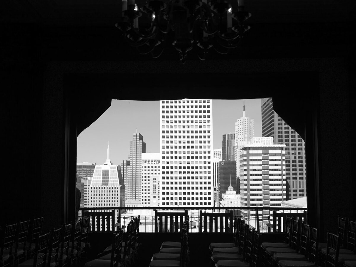 Cityscape framed by a dark window, black and white