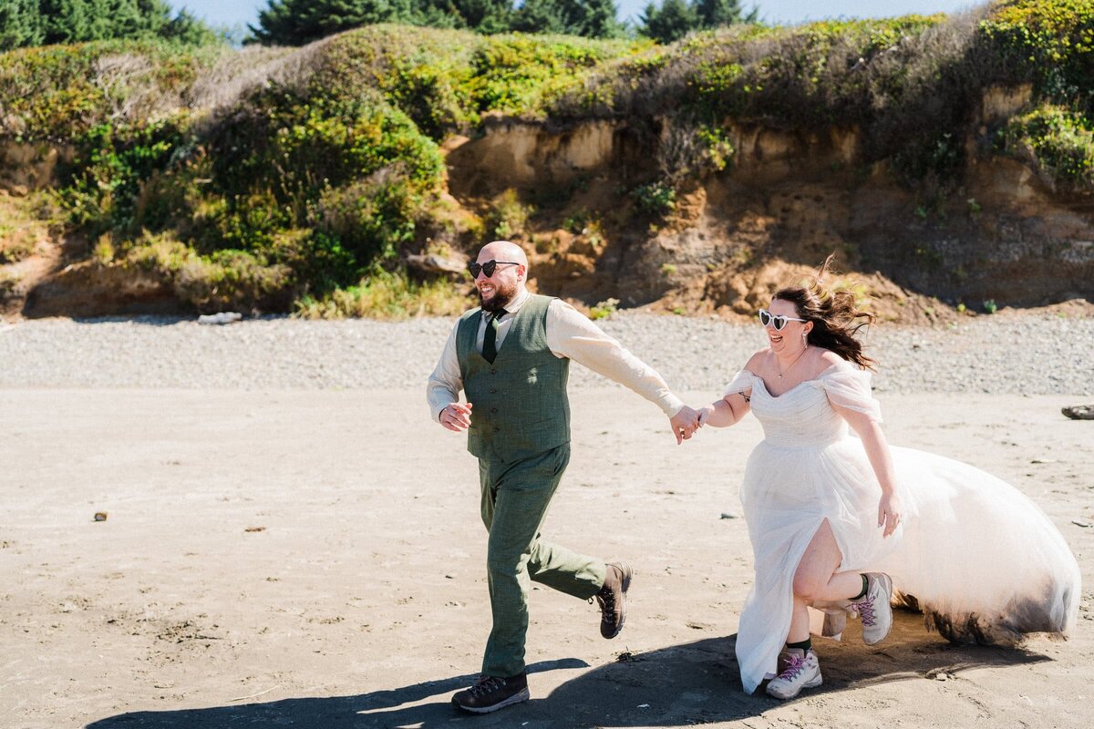 Eloping couple running on the beach during their Washington Coast Elopement.