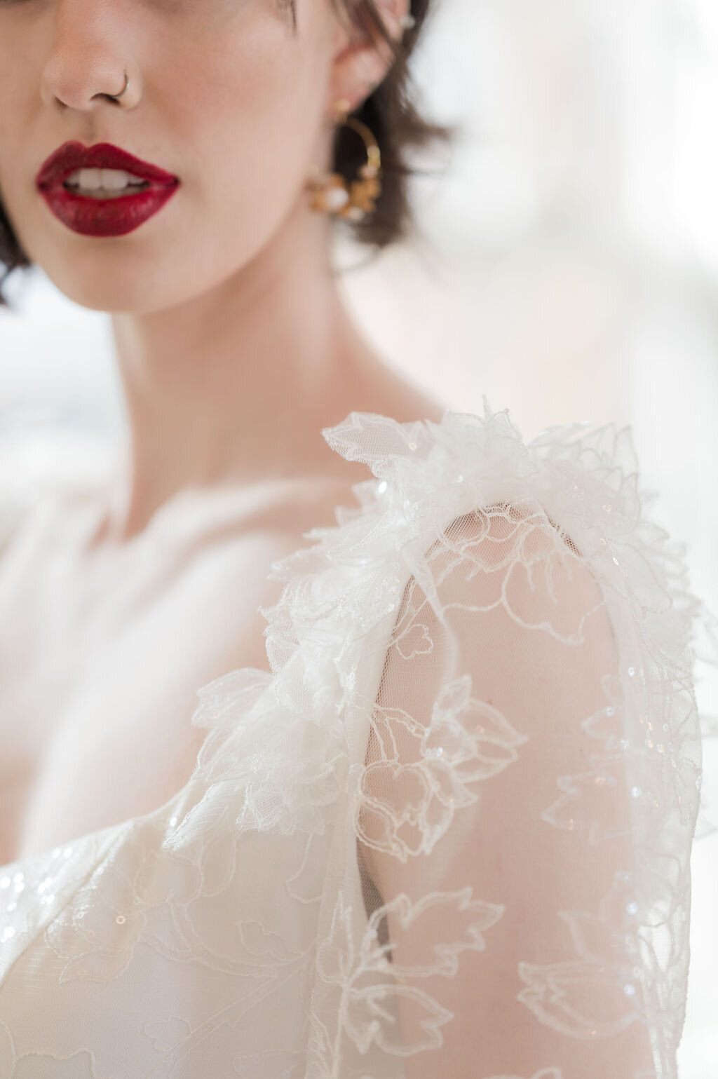3D flowers in a sparkly modern lace on the shoulders of the Gene wedding dress style by indie bridal designer Edith Elan.