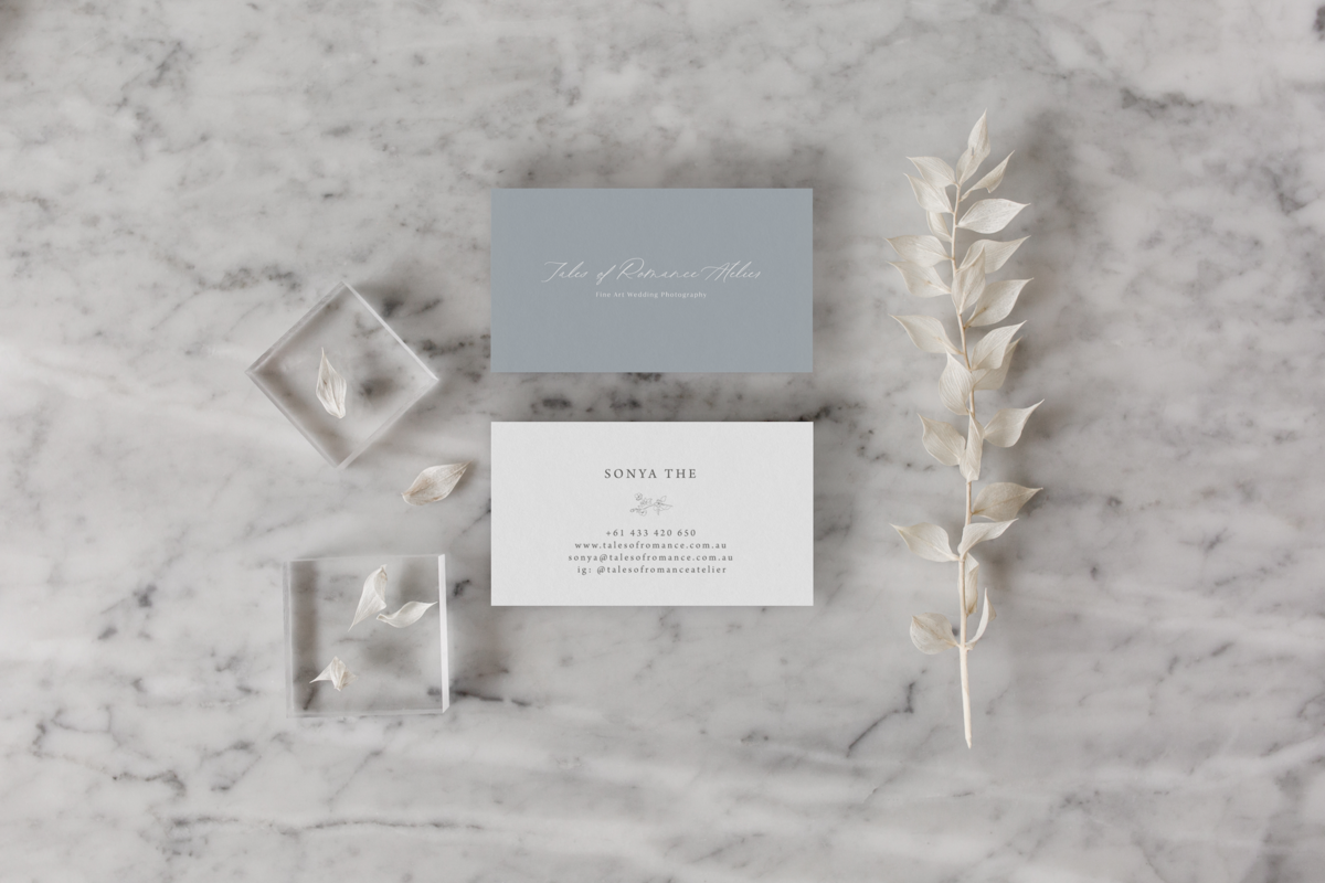 Business cards displayed on marble countertop.