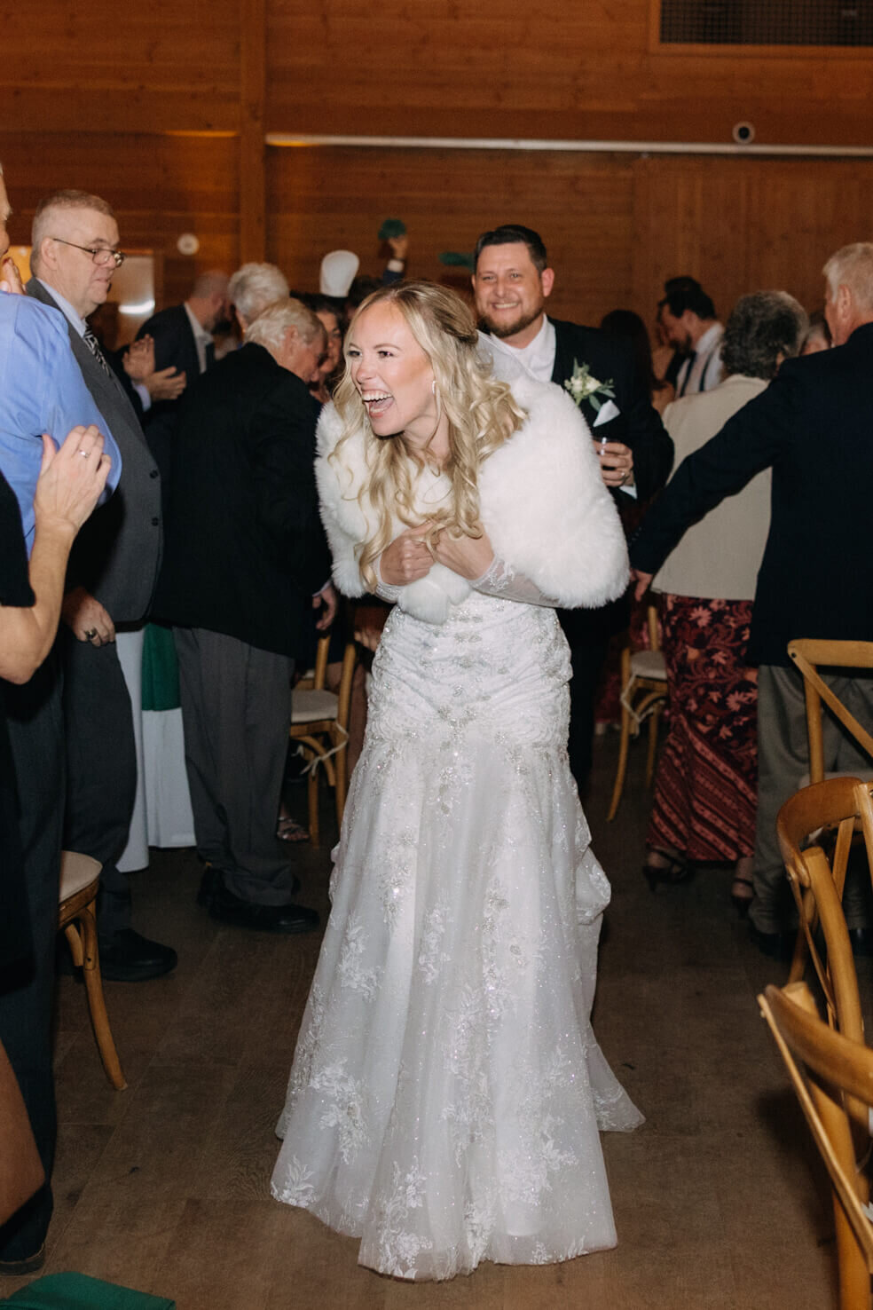 Bride laughing looking at guests at The Lake House on Canandaigua wedding