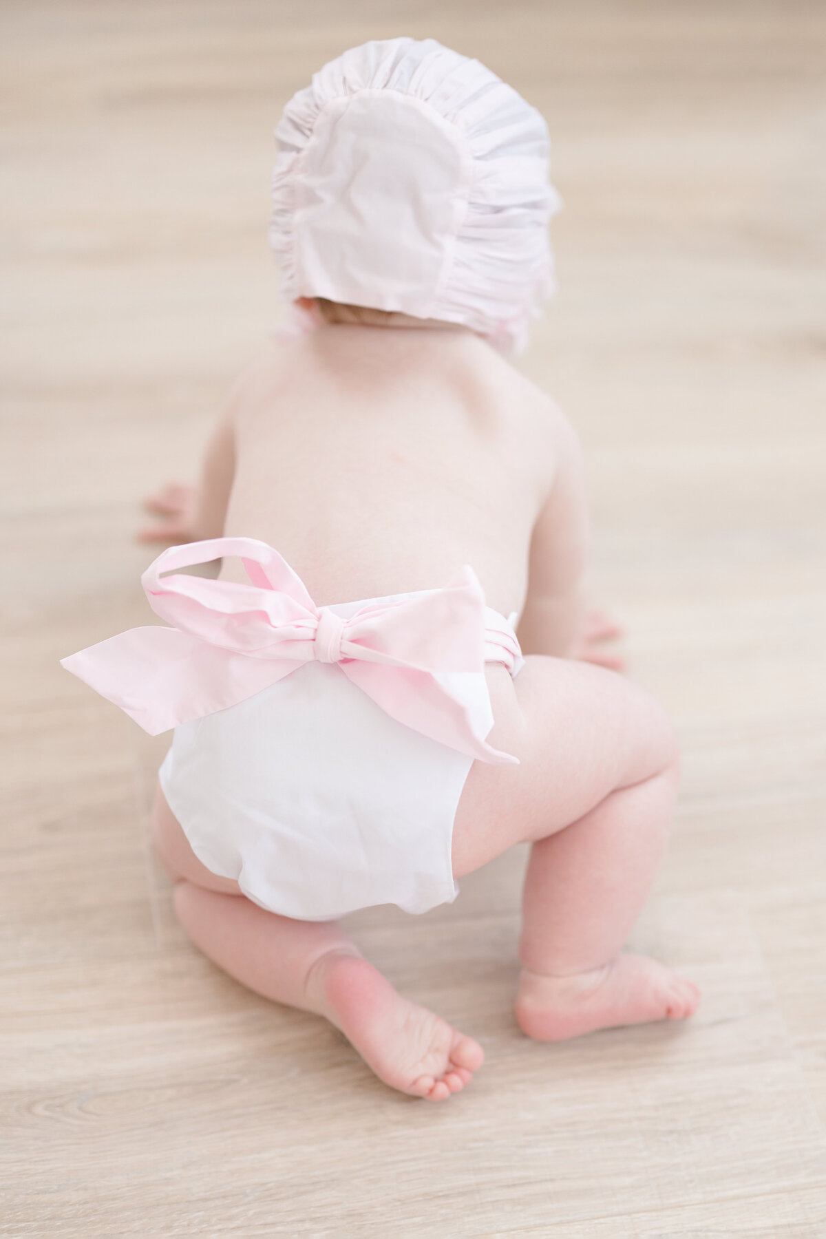 Baby girl wearing a beaufort bonnet outfit taken by a louisville photographer