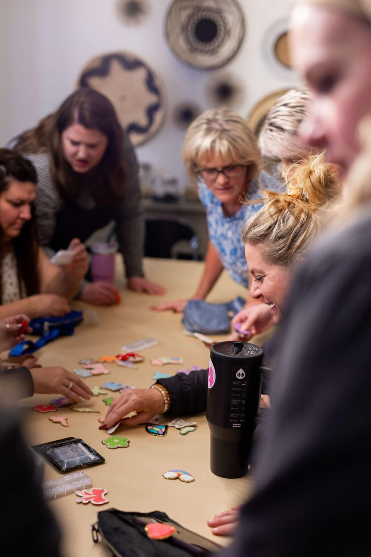 women surrounding table doing crafts
