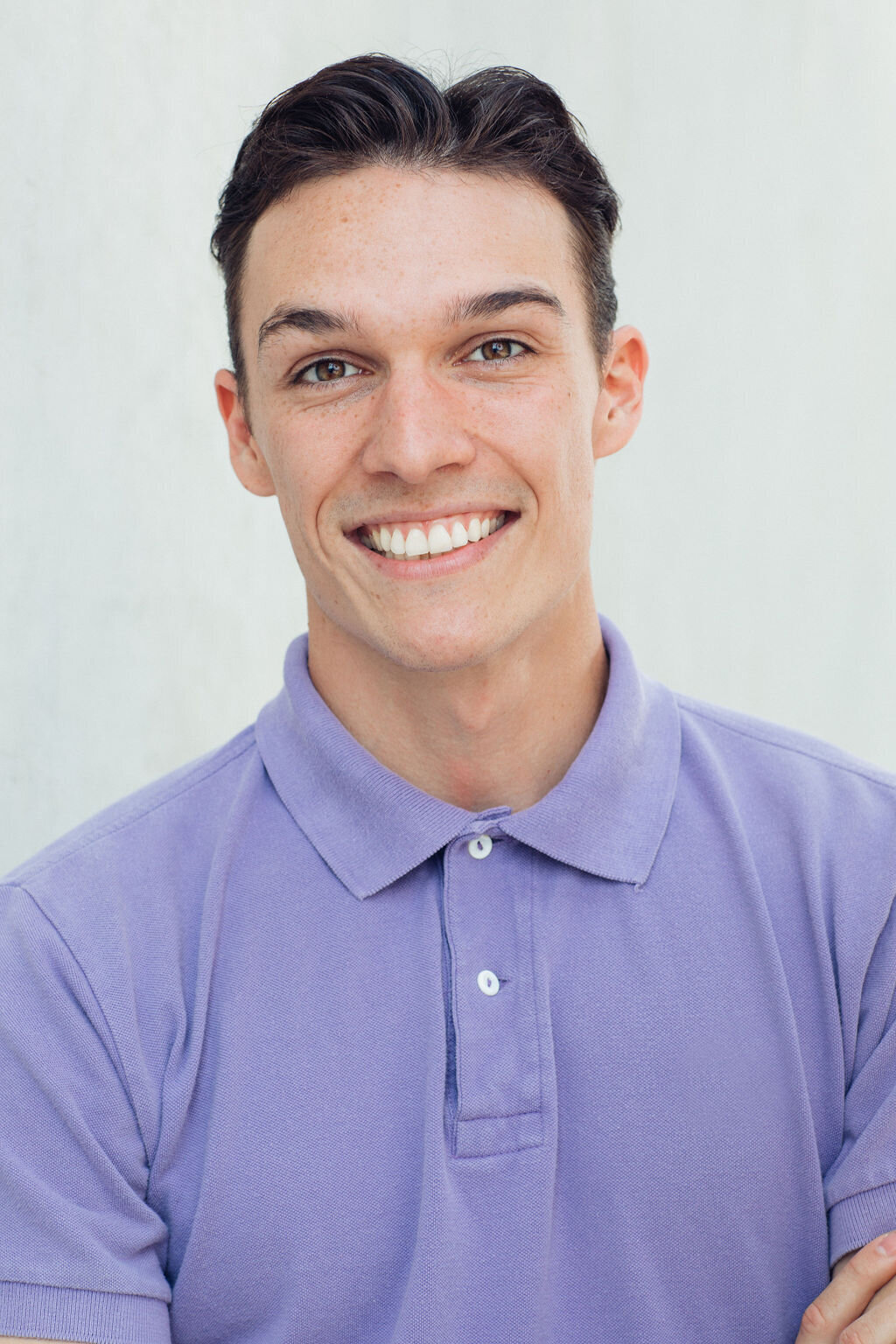 Young Man Wearing Violet Polo Headshot in LA