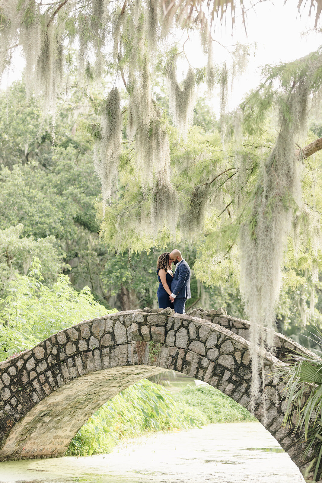 Engagement portrait of couple in New Orleans City Park on bridge
