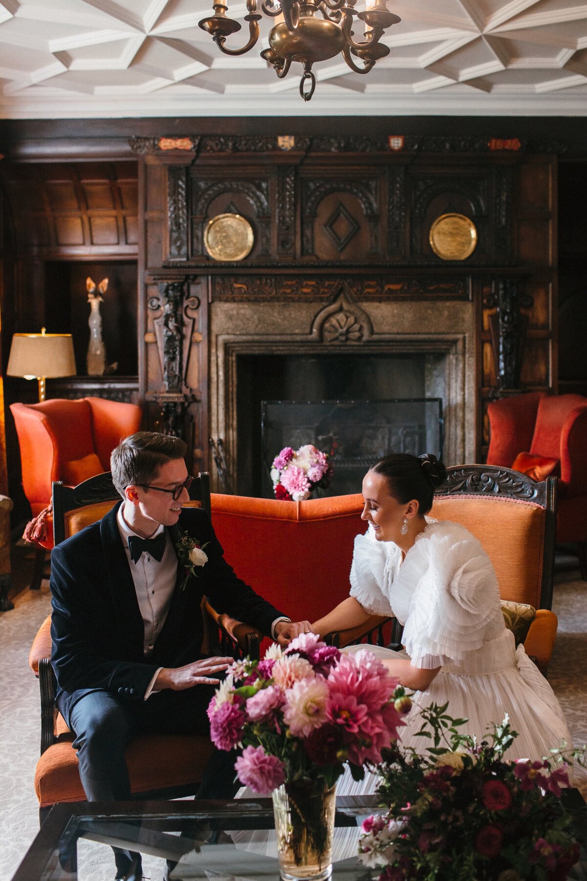 Couple seated in exquisite room at Lewtrenchard Manor