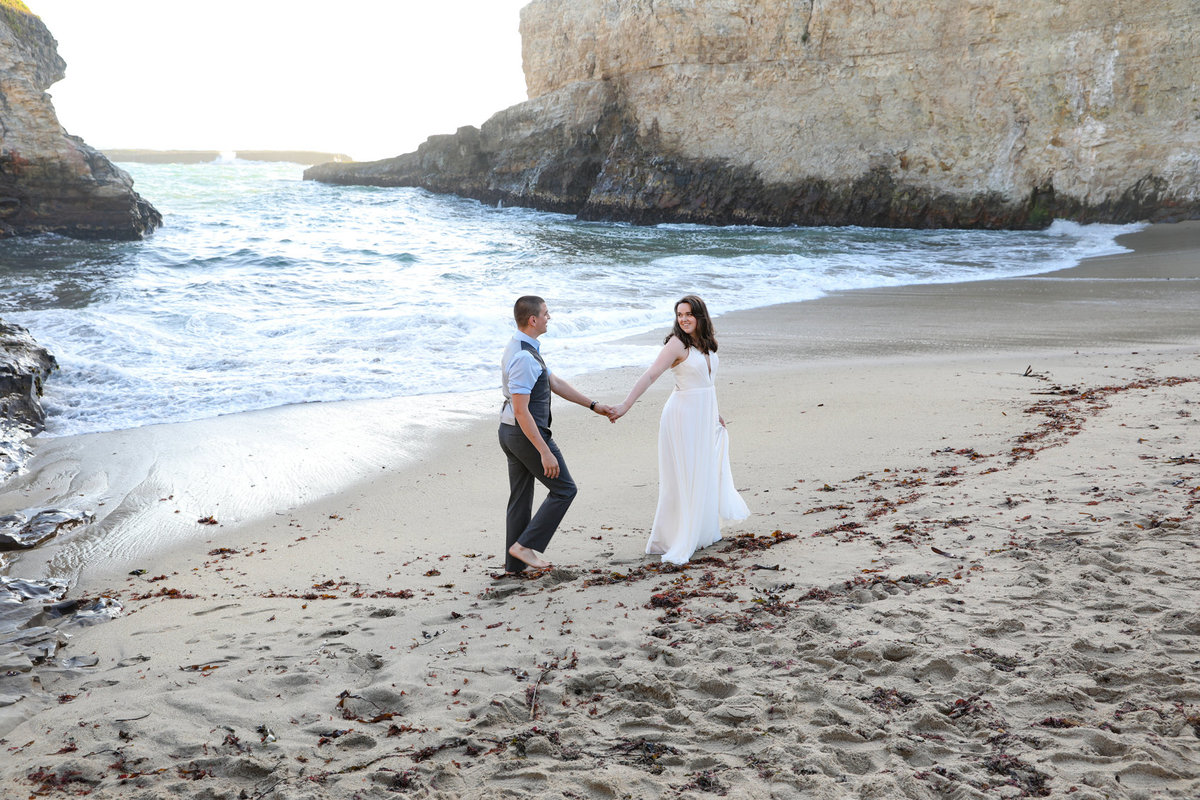 Couple walking on beach, DeNeffe studios, bay area, california