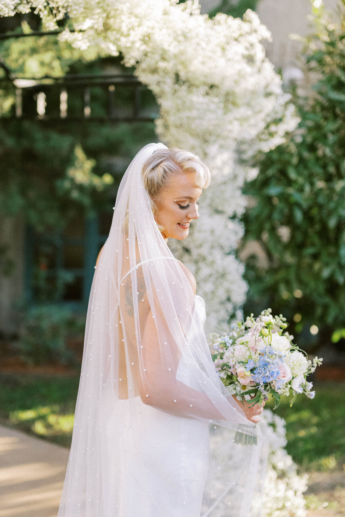 bridal-portrait-in-front-of-babys-breath-arbor