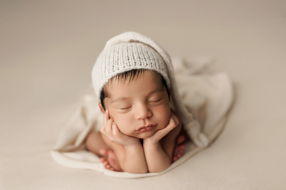 Fort Collins baby boy sleeping with his head in his hands