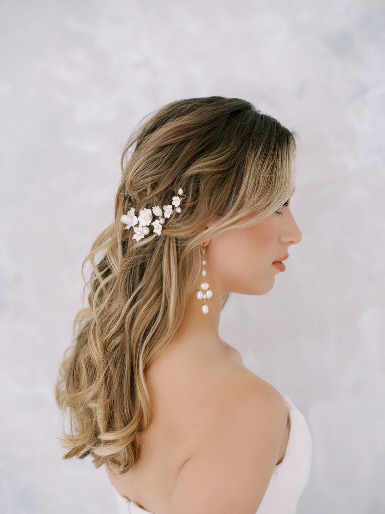 Delicate gold hairpiece with white pearls and flowers, by Joanna Bisley Designs, a romantic and modern wedding jeweller based in Calgary, Alberta.  Featured on the Brontë Bride Vendor Guide.