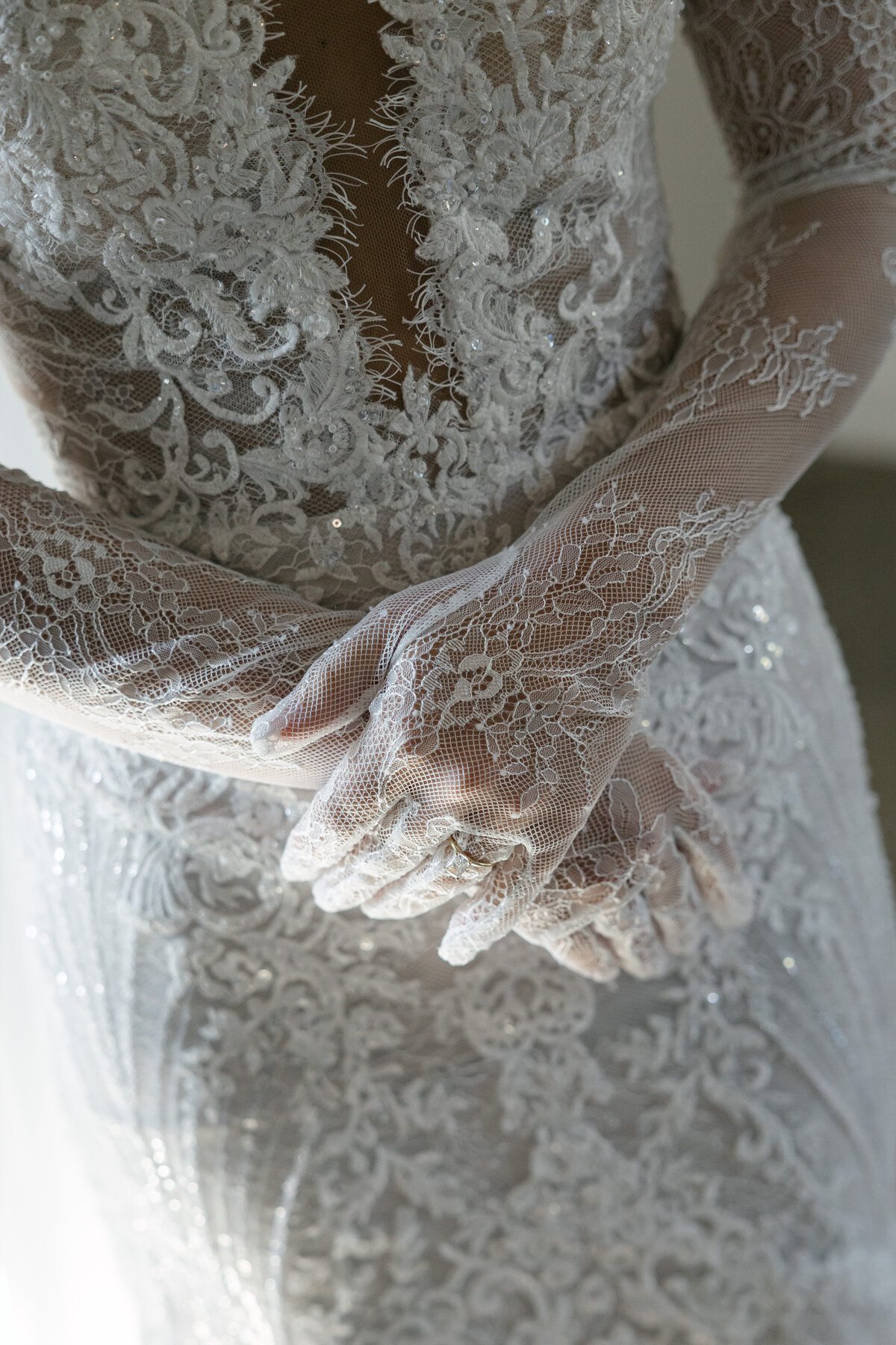 A close-up of the delicate lace bridal glove details at The Overture Center in Madison, highlighting the intricate craftsmanship and timeless elegance that enhance the bride's look.