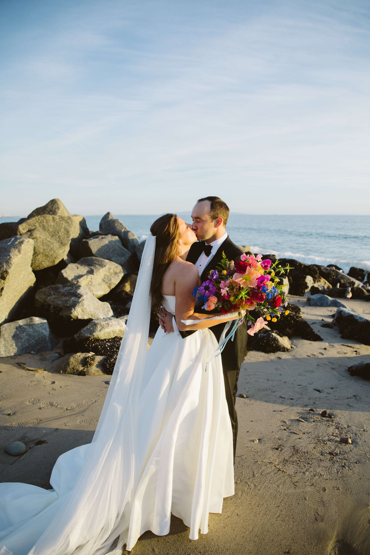 Bride and groom post wedding pictures outside of Bel Air Bay Club on the beach