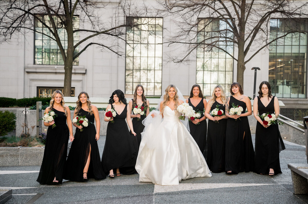 bride and bridesmaids posing for photos in mellon square of pittsburgh