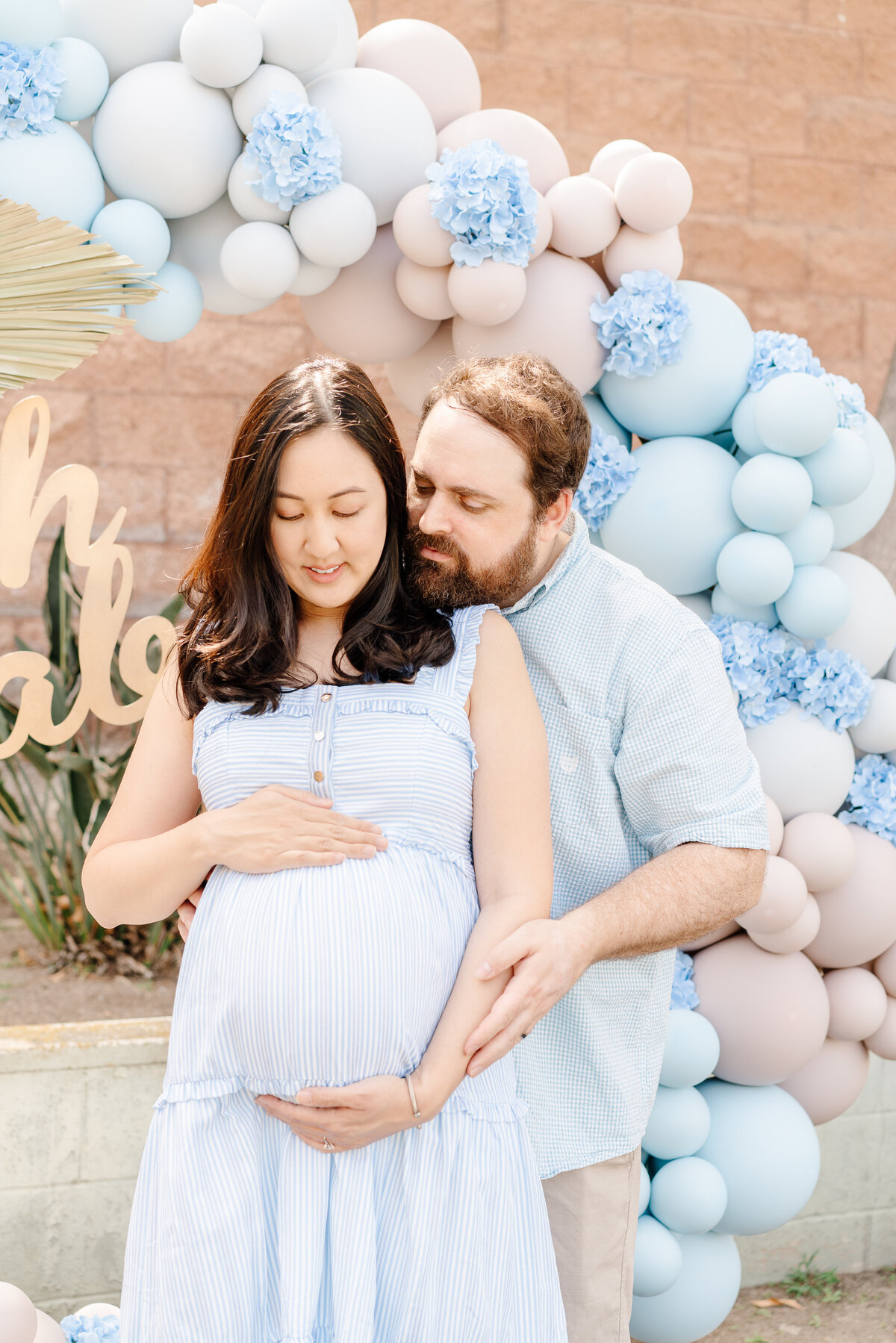 Expecting parents celebrate baby announcement with blue theme
