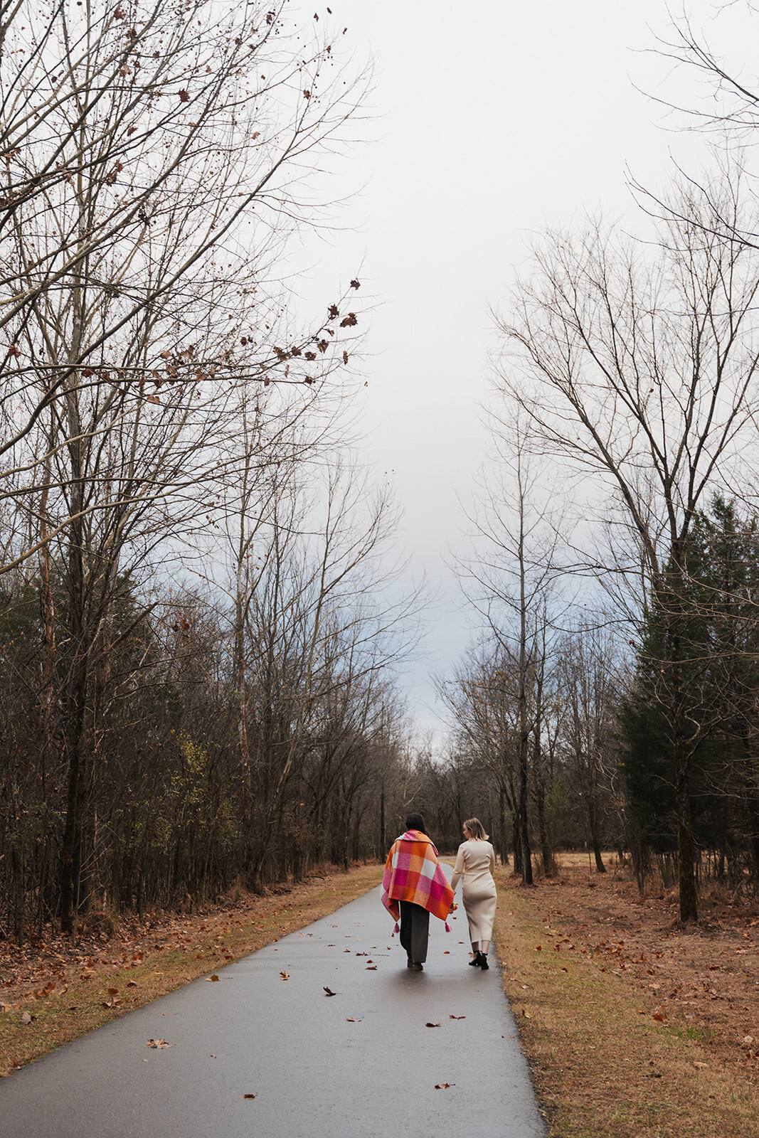 Women walk down a park road in Nashville Tennessee following their LGBTQ elopement 