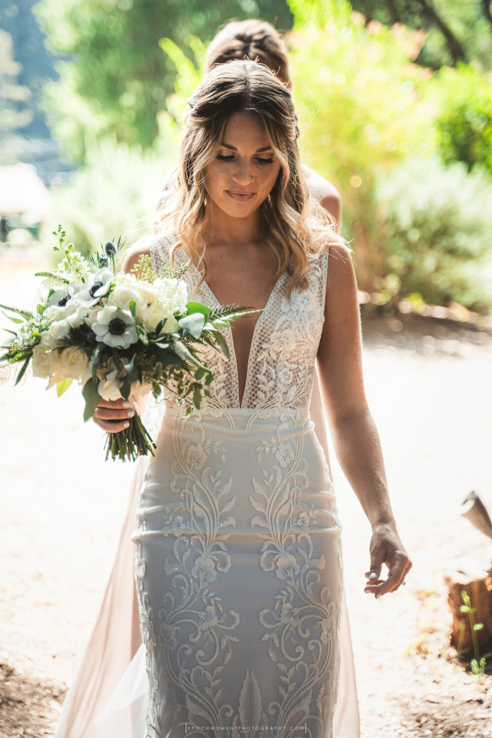 Bride walking in the aisle while holding her bouquet