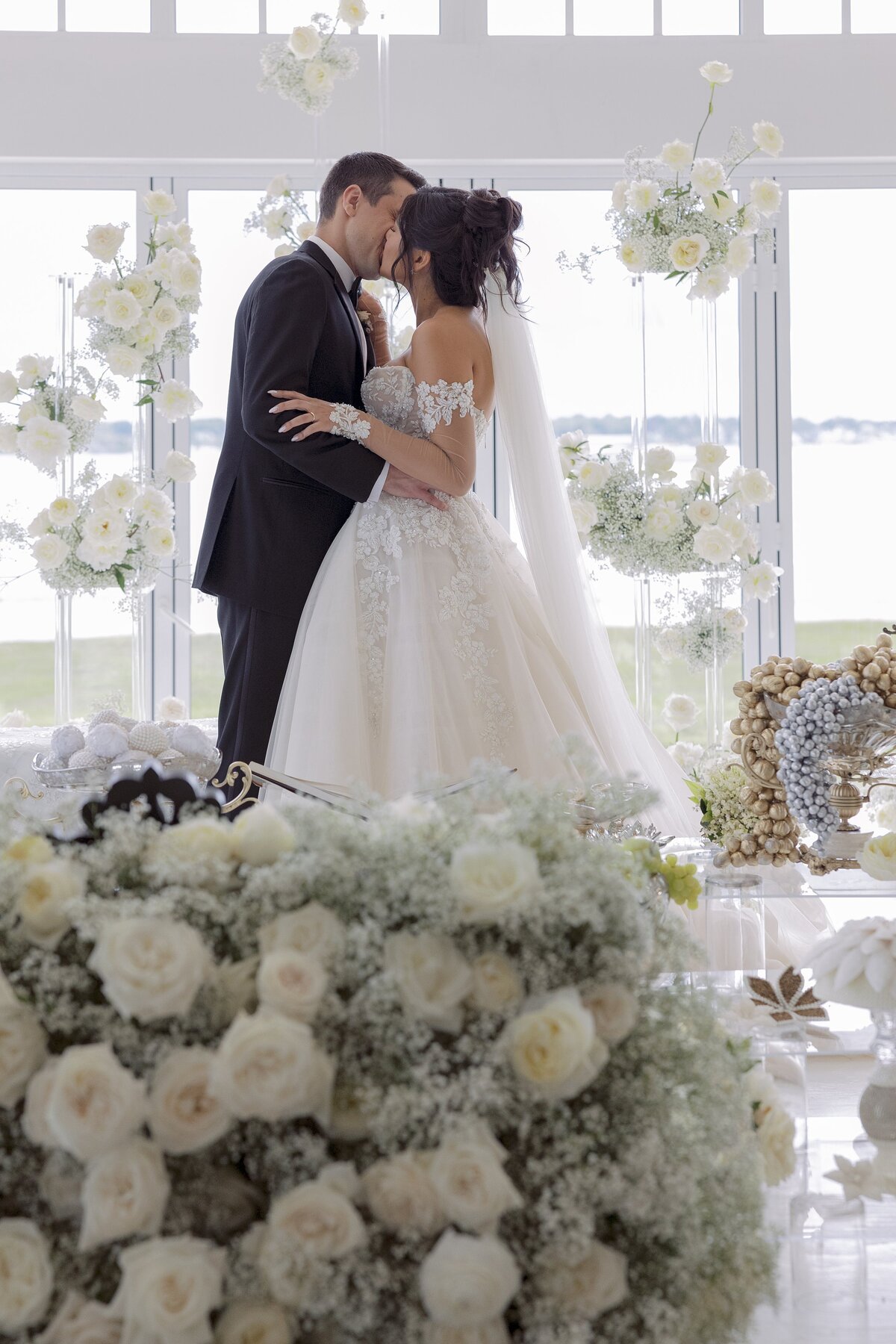 Bride and Groom share first kiss during Persian wedding ceremony at Belle Mer, Newport.