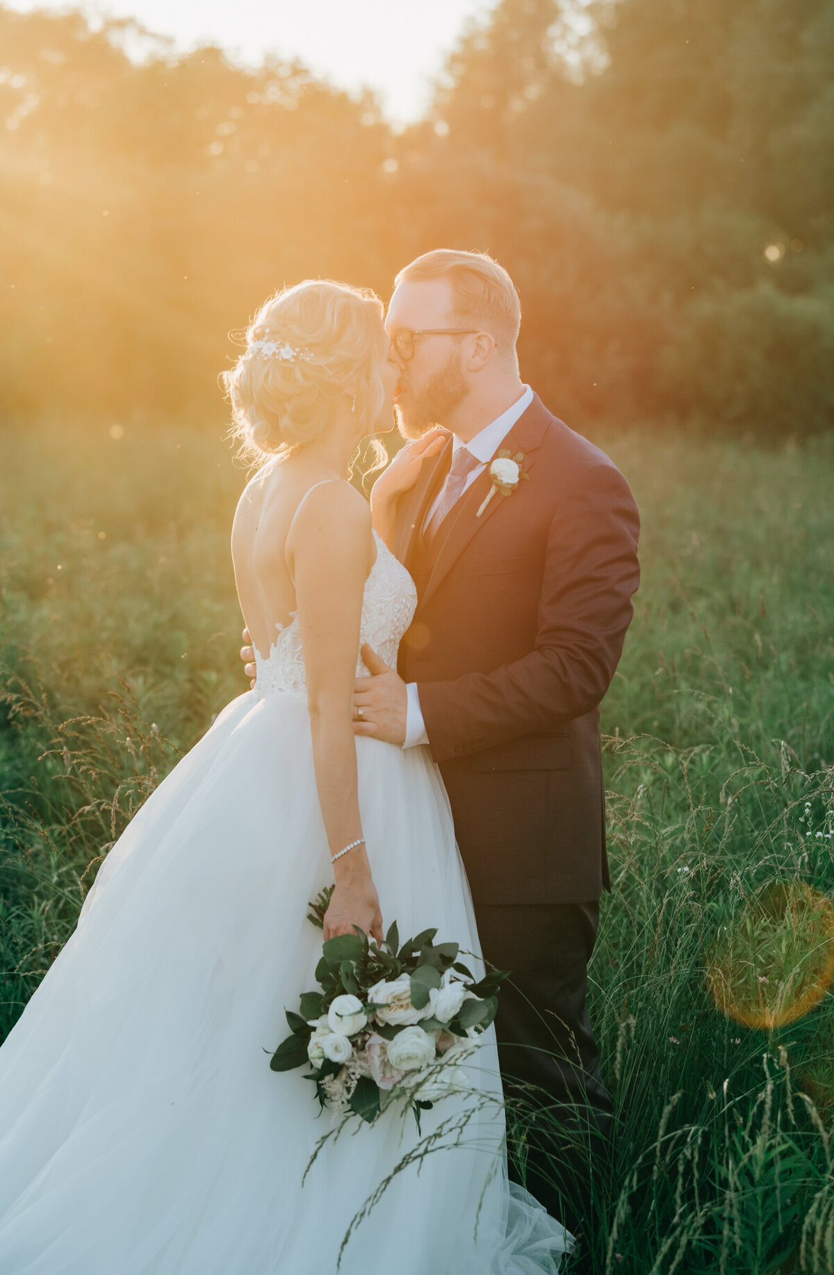 Glowing bride and groom during glamorous sunset wedding portraits