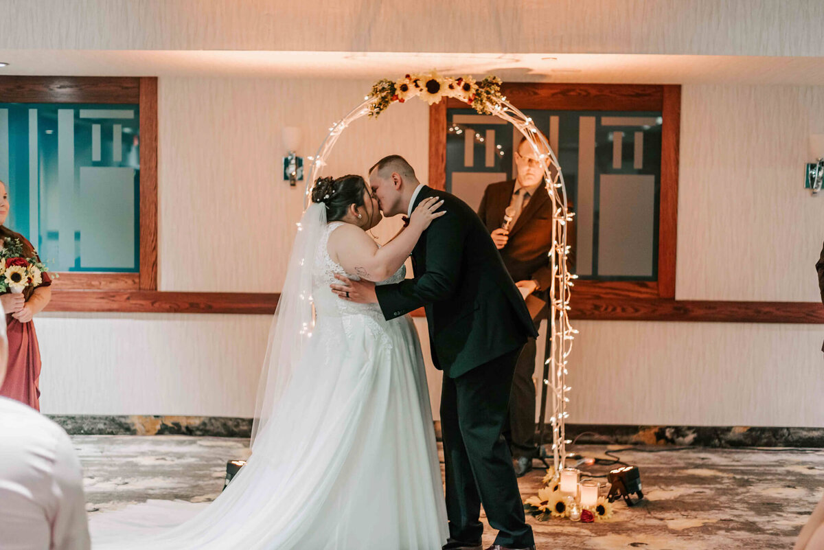 Bride and groom share 1st kiss.