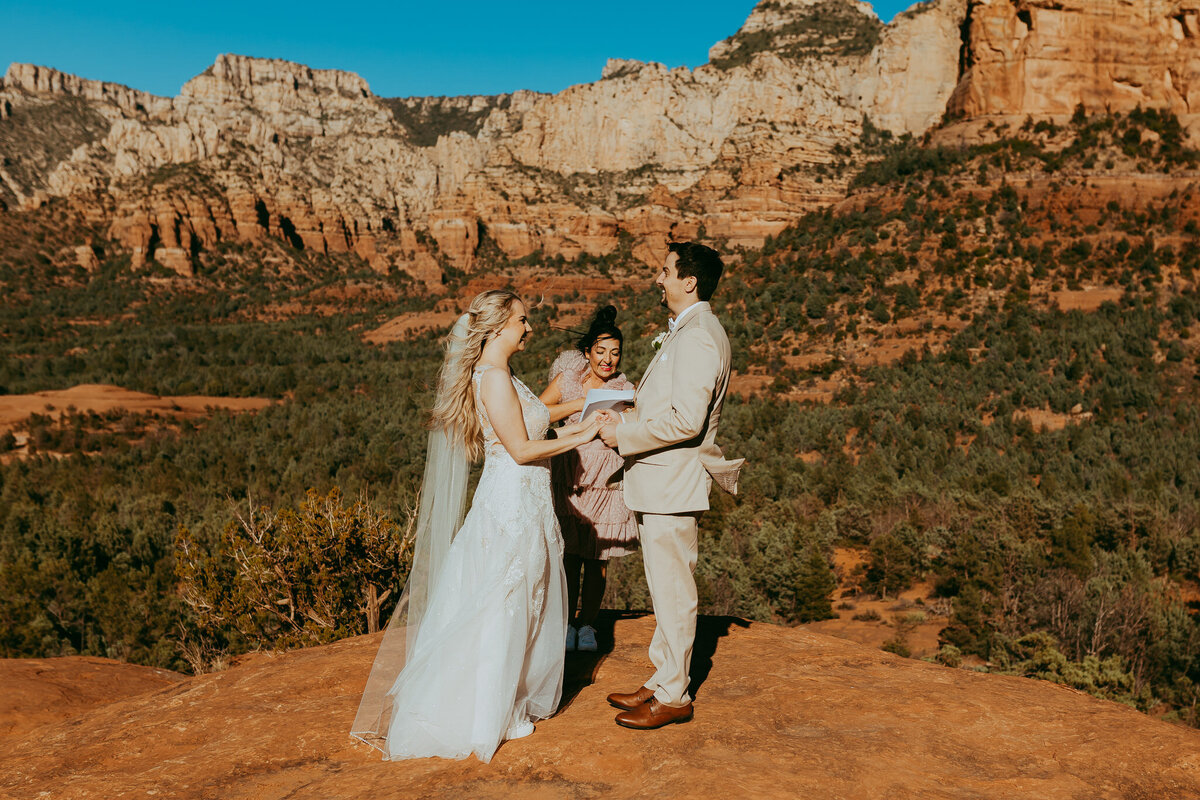 couple getting married with sedona landscape in photo