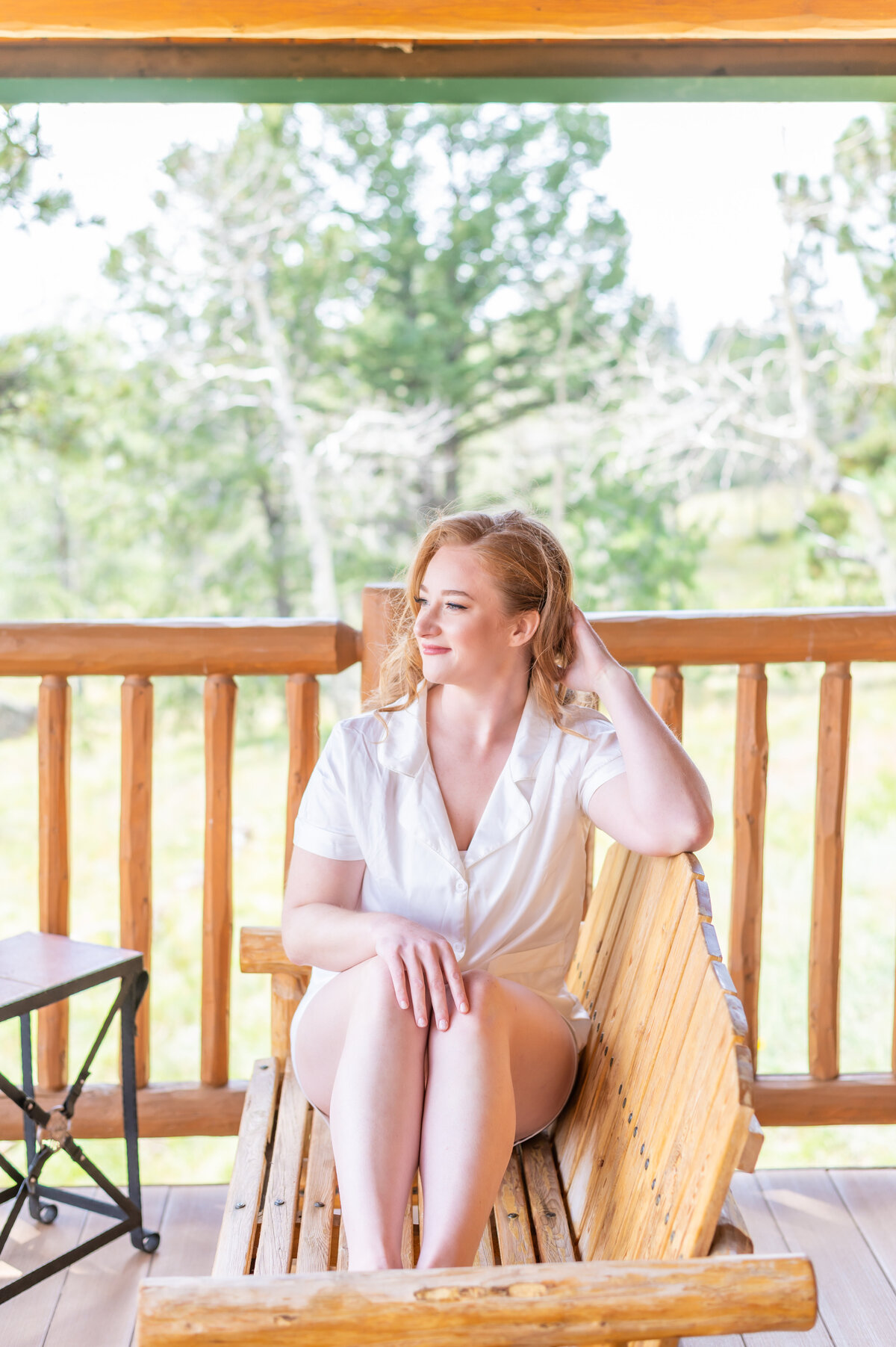 Bride sitting down looking out at mountain views at Mueller State Park in Divide, Colorado