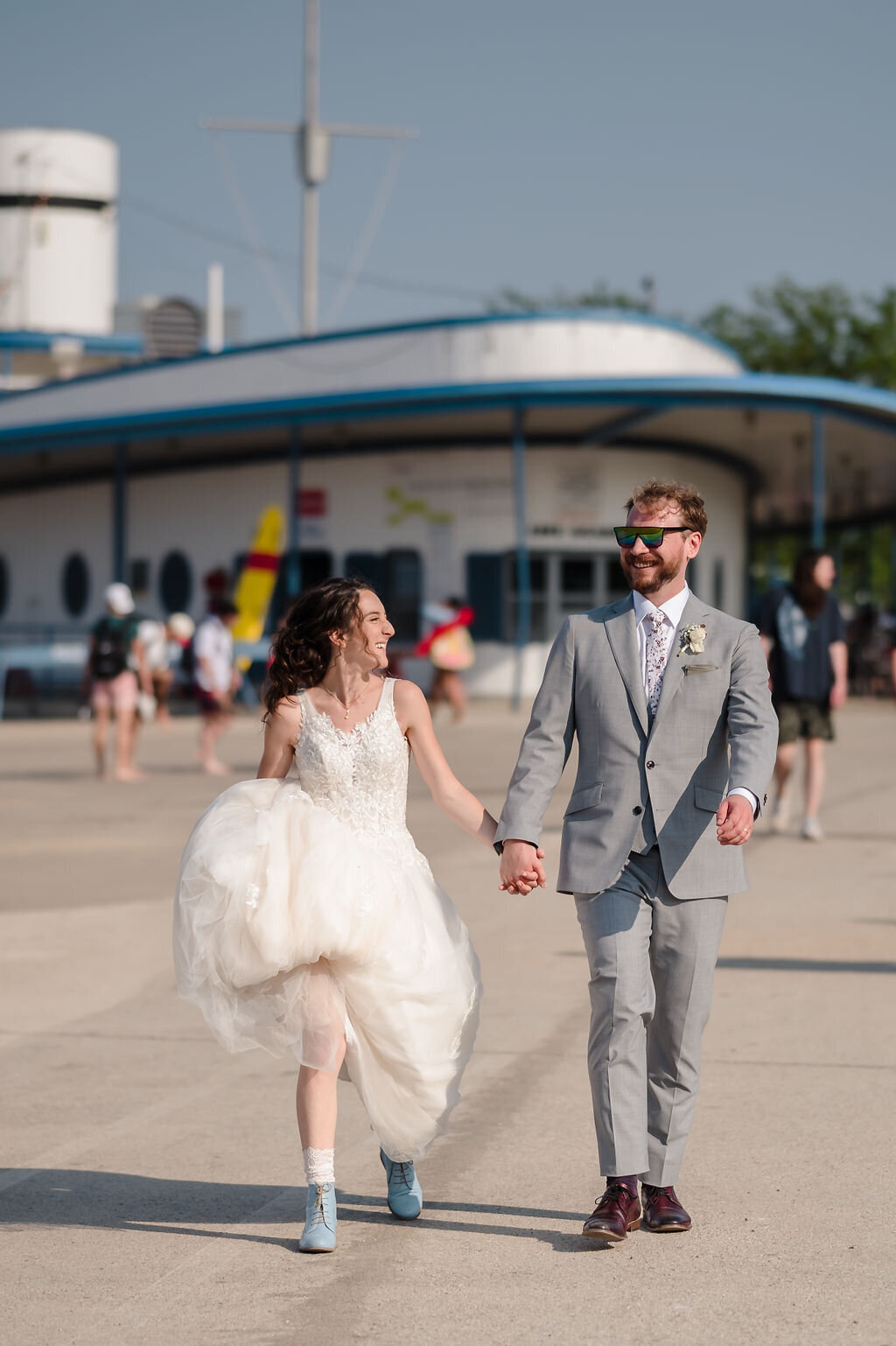 Bride and groom walk on North Avenue Beach In Chicago, IL