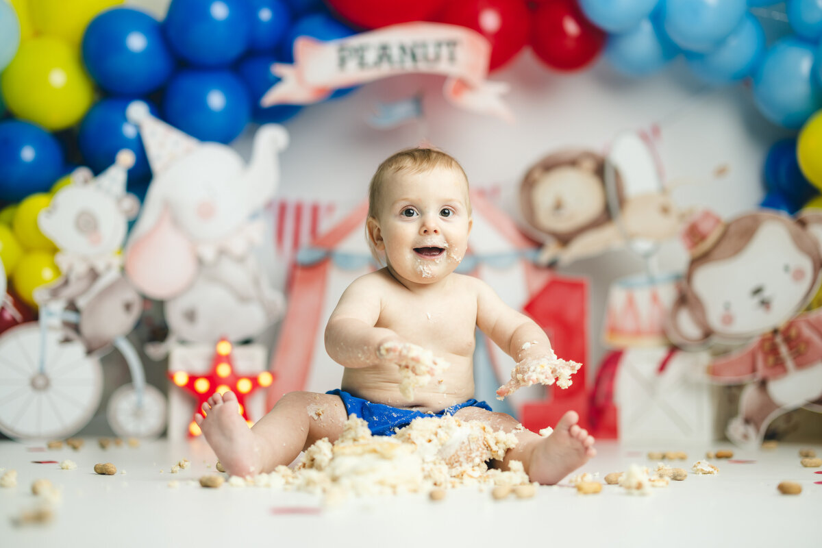  Baby boy with circus themed first birthday cake smash in Canton GA photography studio
