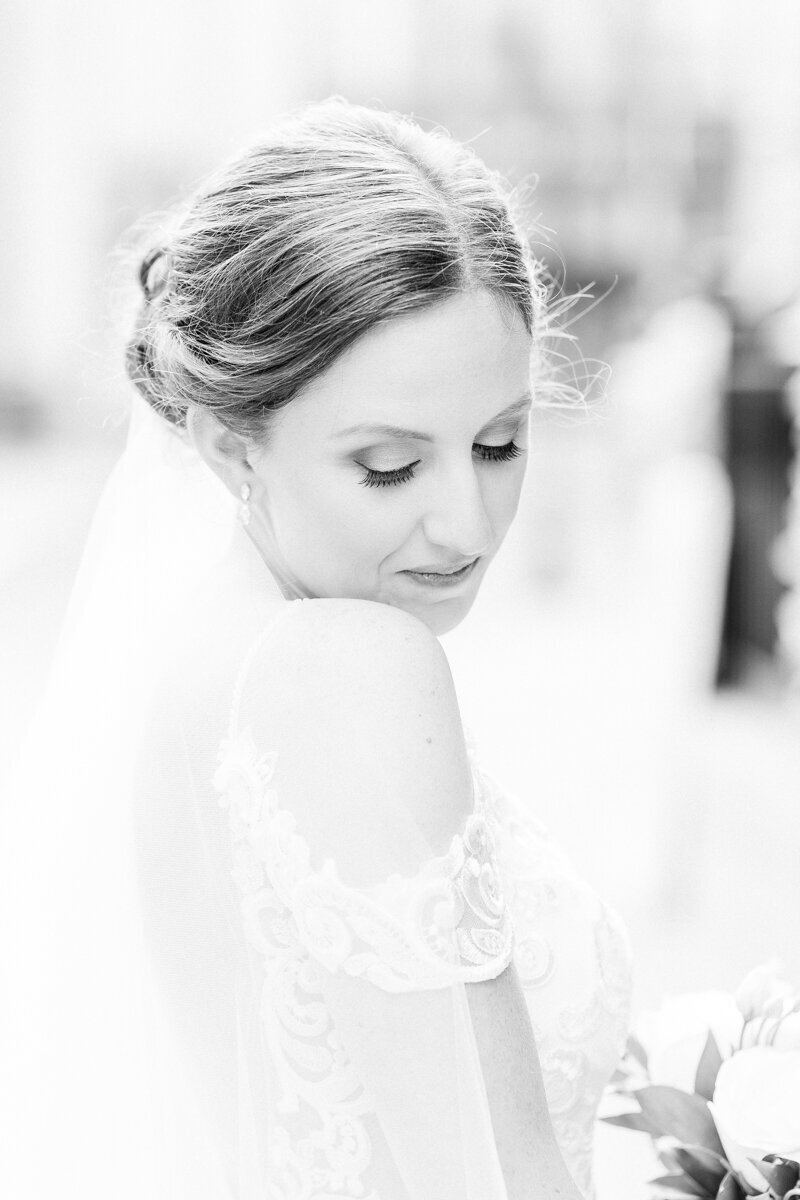 Classic black and white portrait of bride looking over her shoulder in Schenectady, NY at Key Hall at Proctors