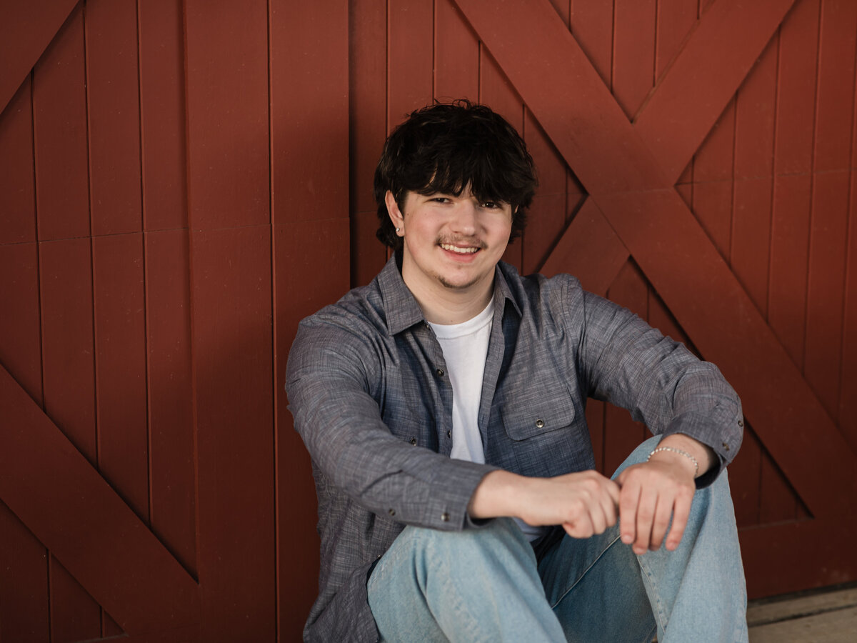 male high school senior in blue button down posed at Westcreek reservation for senior portraits