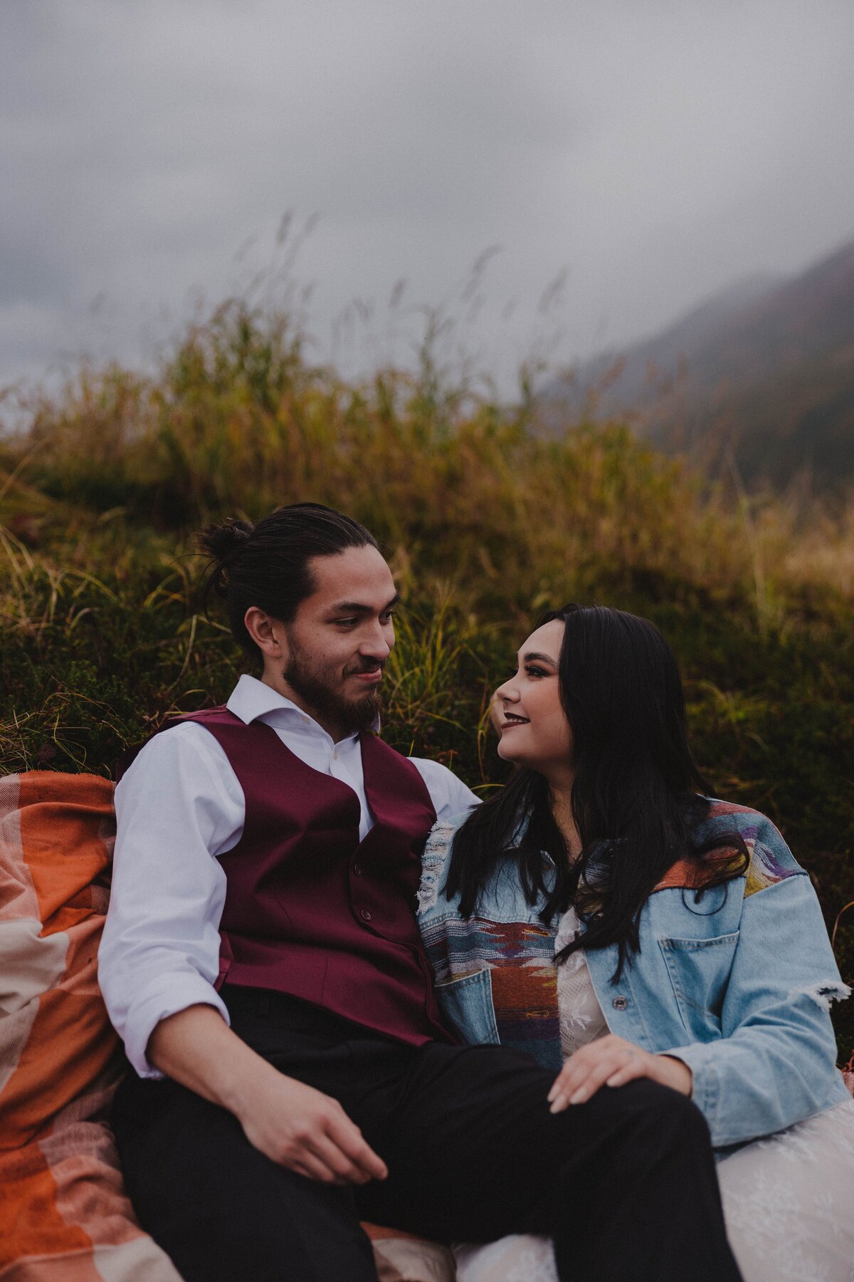 A newlywed couple relaxes on a hillside in Turnagain Pass, Alaska