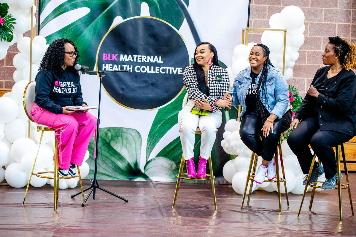 A group of Black women, including massage therapist Jamel Morant, gather at the Black Maternal Health Collective panel to discuss and promote maternal health and wellness. A powerful moment highlighting the importance of Black women’s health and advocacy.