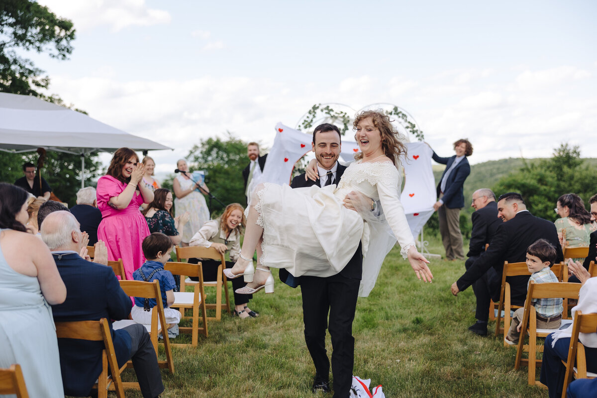 LGTBQ outdoor wedding, women looking at each other at outdoor wedding ceremony, Finger Lakes, NY