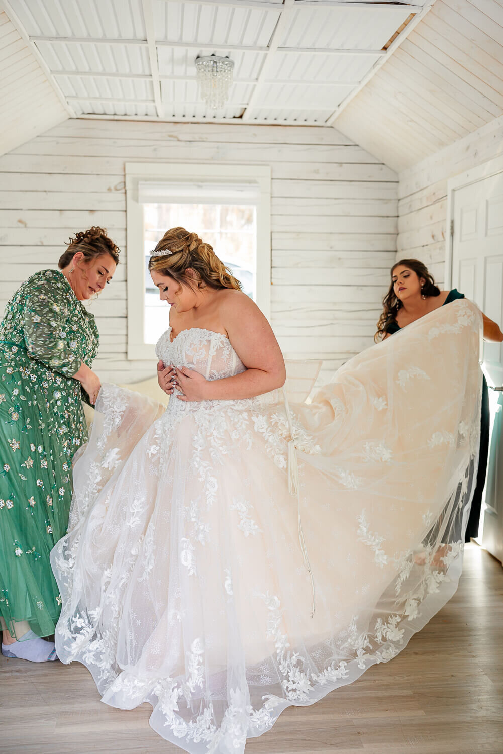 wedding day at pinecrest event center bride putting on dress