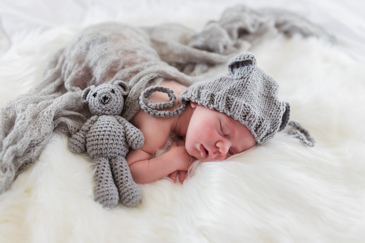 Newborn baby in grey bear costume