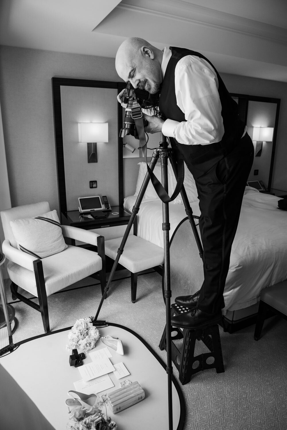 A man is taking a picture in a hotel room