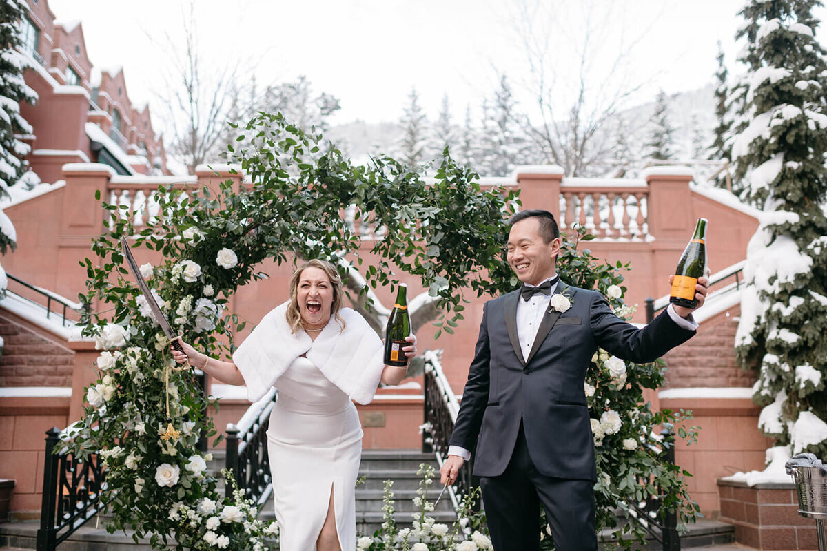 Bride and Groom at St. Regis Aspen Wedding celebrate their marriage with champagne.