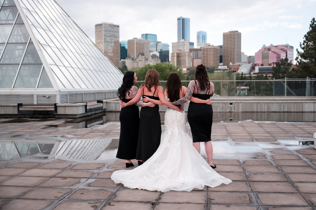 bride and bridesmaids pose for wedding portraits